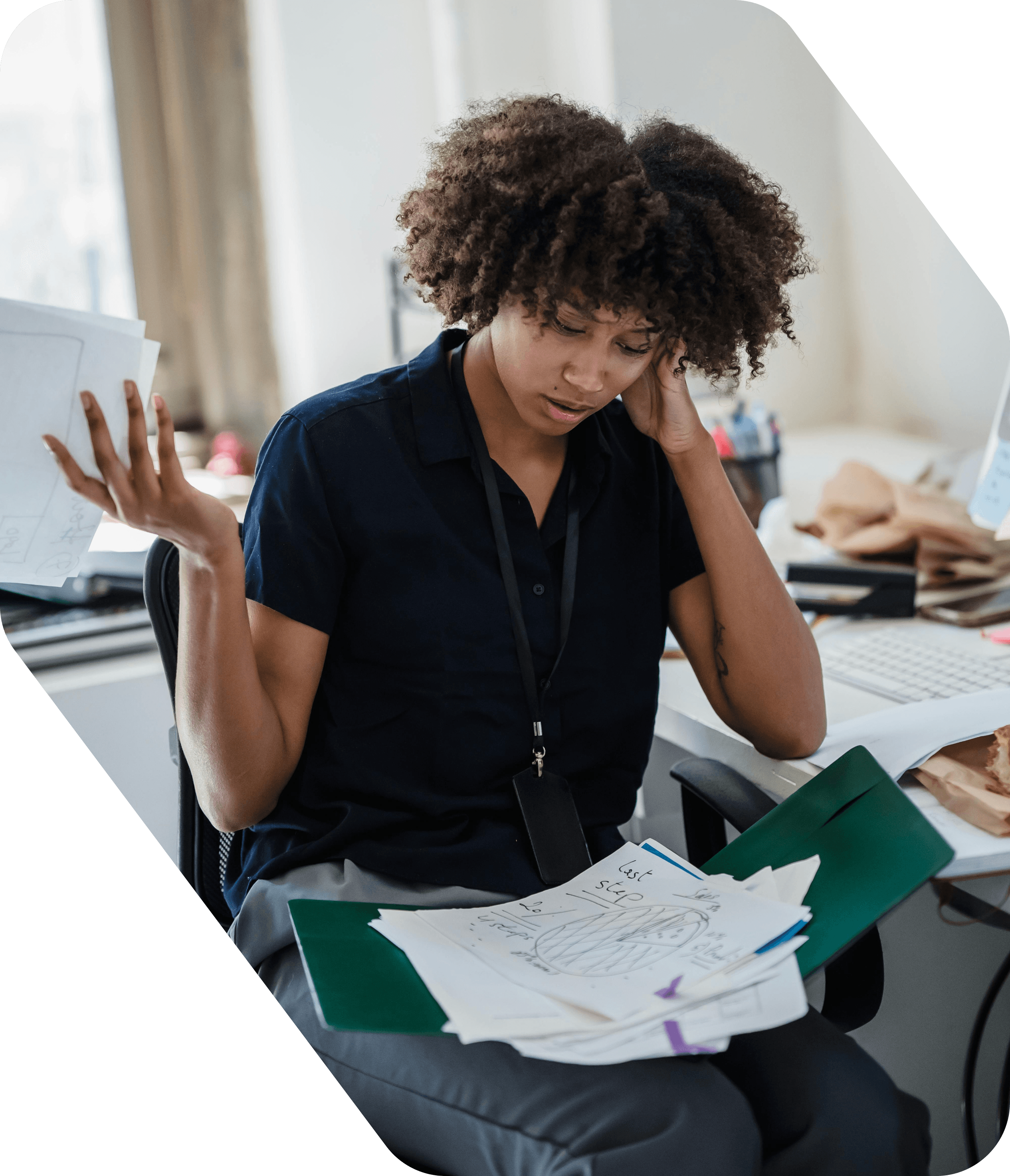 A homeschooling parent looking overwhelmed by a pile of paperwork at a cluttered desk